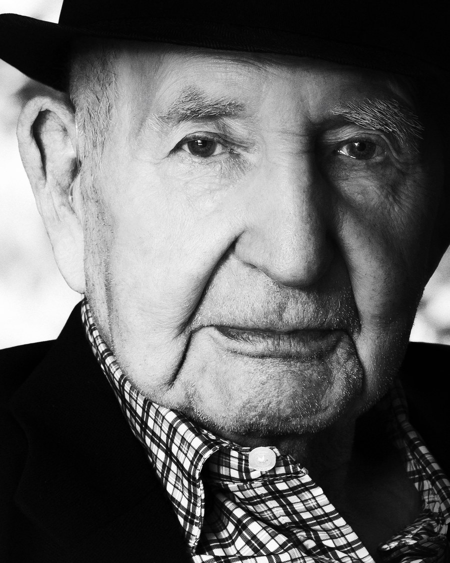 Bob Rummer, a close portrait in his hat and a checked shirt.